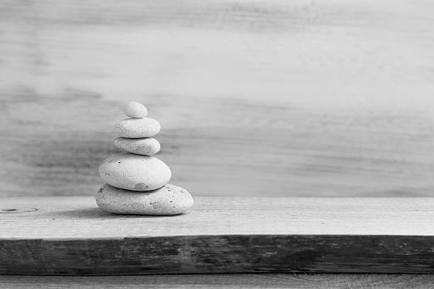 Pyramid of zen stones on a wooden board