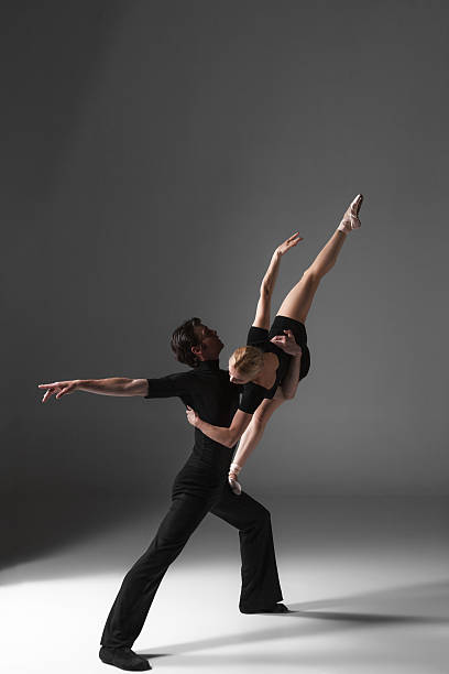 istock two young modern ballet dancers on gray studio background 479581360