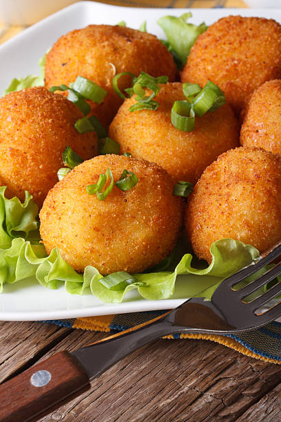 istock potato croquettes and vegetables close-up. Vertical 479585414