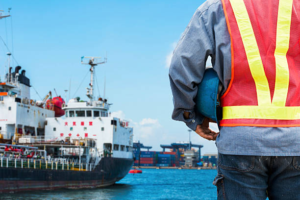 istock Harbor dock worker talking on radio with ship background 479587124