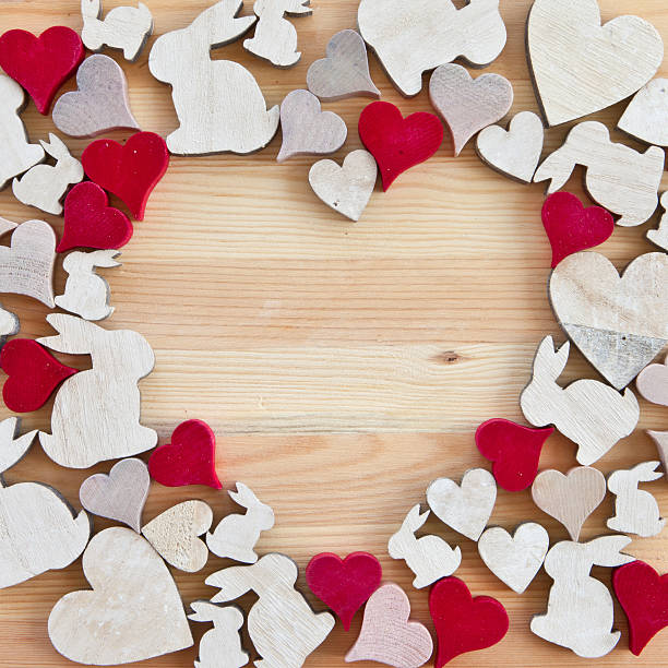 istock Wooden background with hearts and easter bunnies 479590349