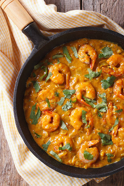 istock Shrimp in curry sauce in pan close-up Vertical top view 479590580