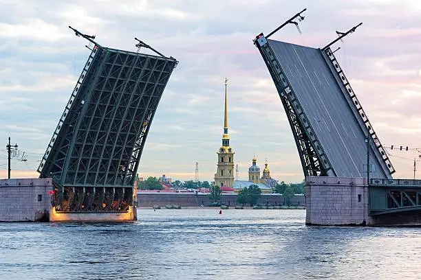 View of the Peter and Paul fortress and raised Palace bridge in summer white nights, St. Petersburg