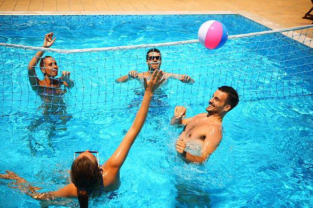istock Friends playing volleyball in a pool. 479591066