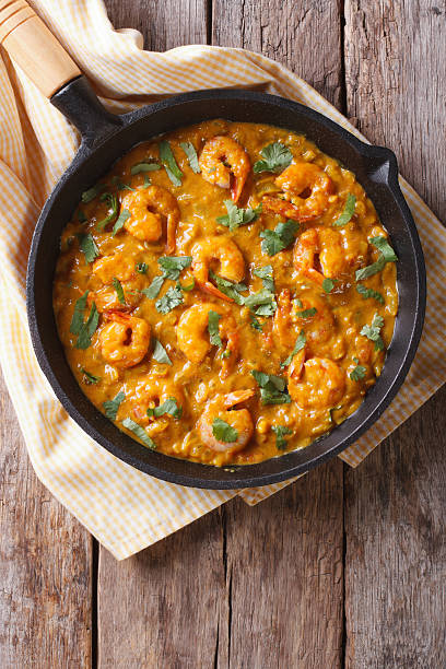 istock Shrimp in curry sauce in the pan. Vertical top view 479594228