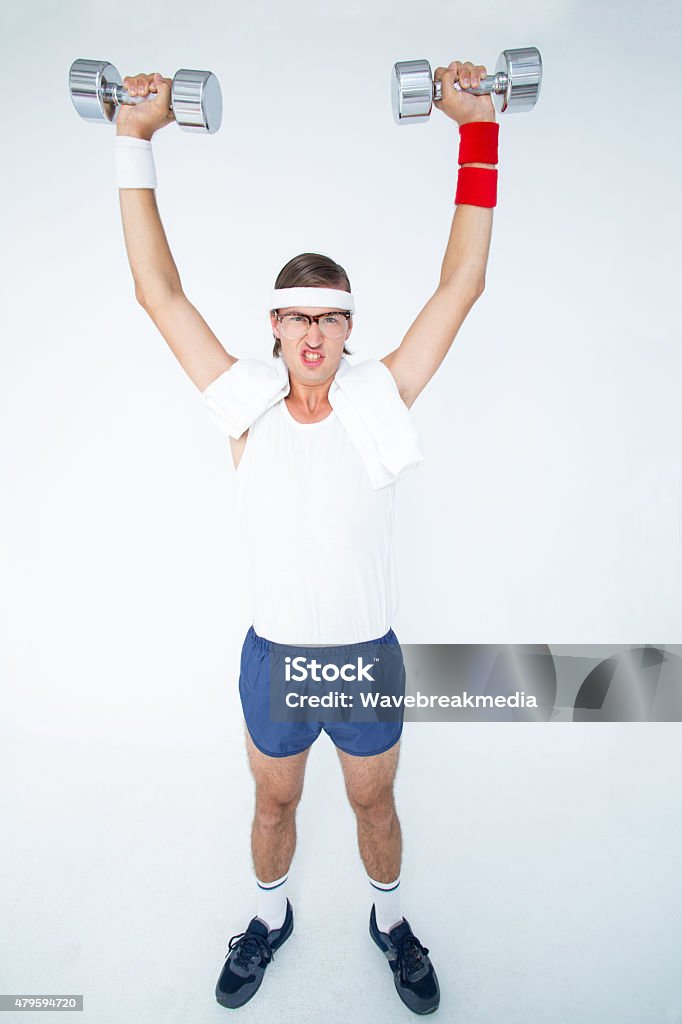 Geeky hipster lifting dumbbells in sportswear Geeky hipster lifting dumbbells in sportswear on white background 20-24 Years Stock Photo