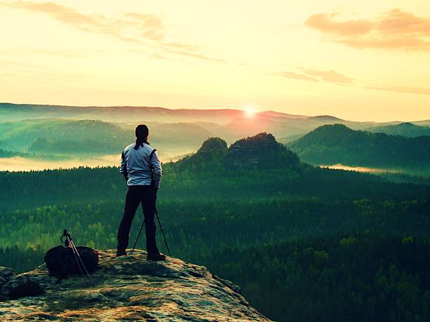 istock Man in white takes photos with camera on tripod 479594804