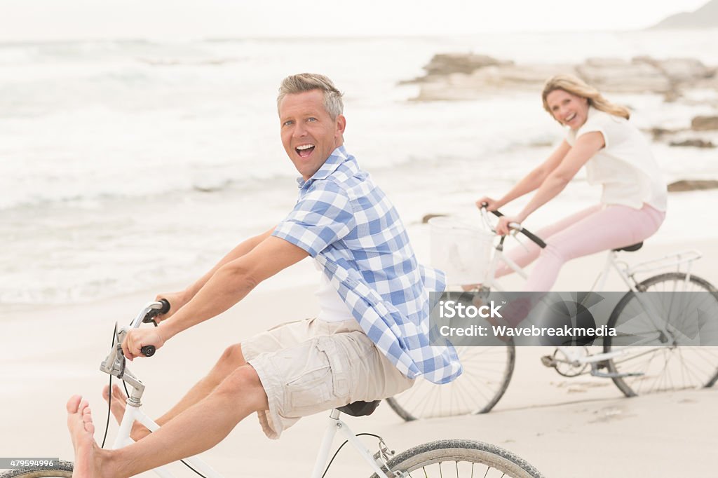 Casual couple on a bike ride Casual couple on a bike ride at the beach Cycling Stock Photo