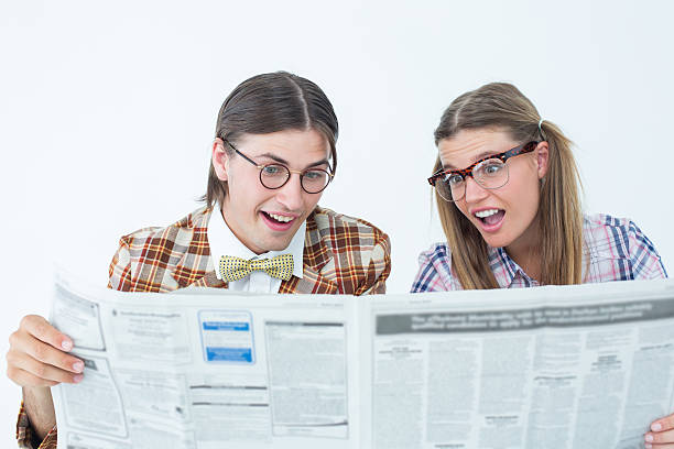 istock Geeky hipsters reading the newspaper 479595072