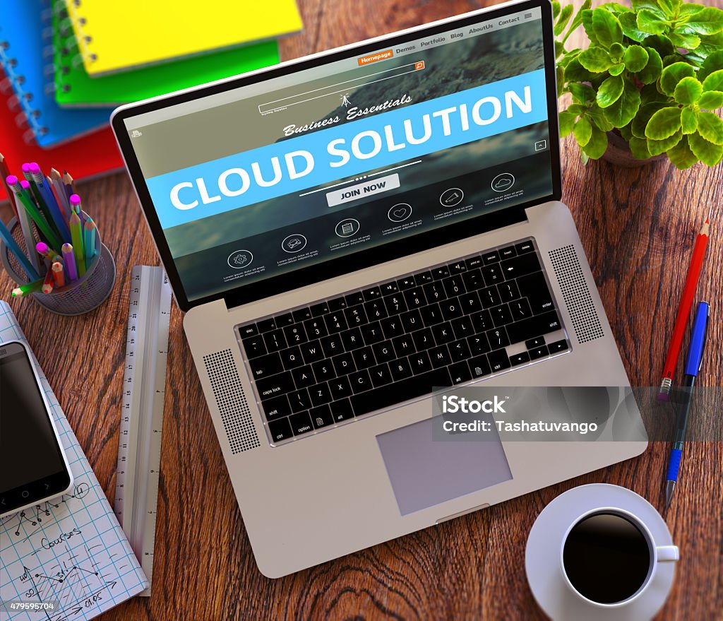 Cloud Solution Concept on Modern Laptop Screen Cloud Solution Concept. Modern Laptop and Different Office Supply on Wooden Desktop background. 2015 Stock Photo