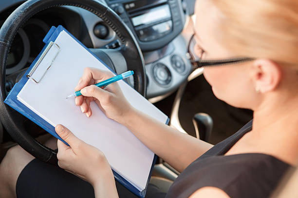 istock Woman sighing papers inside car 479598340