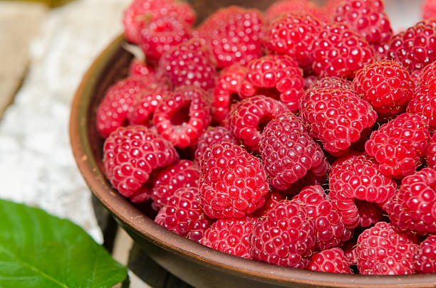 istock fresh ripe raspberries in clay plate 479598364