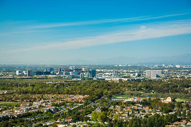Irvine and Greater Orange County skyline aerial Irvine and Greater Orange County skyline aerial view, with Irvine residential neighborhoods in the foreground and the Irvine Business Complex skyline in the center of the scene, with other Orange County skylines including Garden Grove and Anaheim in the very far distance. anaheim california stock pictures, royalty-free photos & images