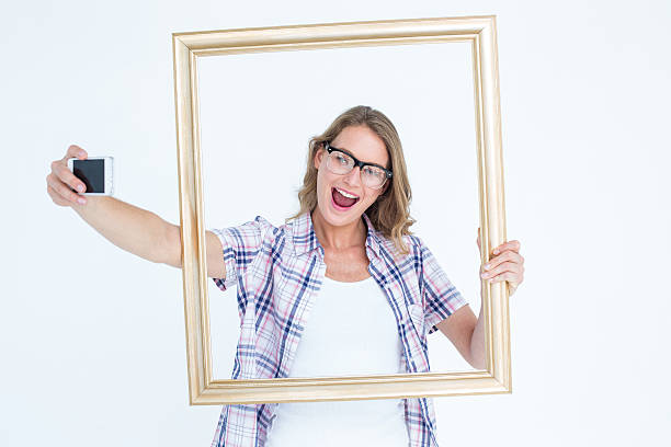 istock Pretty geeky hipster taking selfie with smartphone 479603764