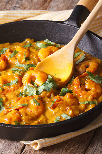istock Prawns in curry sauce in a frying pan close-up. vertical 479603922