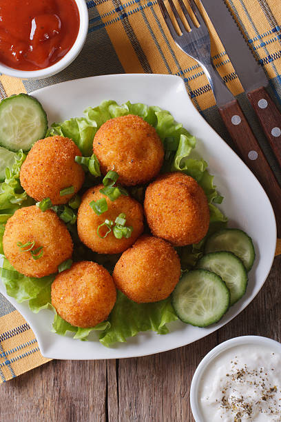 istock potato croquettes with lettuce and cucumber top view vertical 479603936