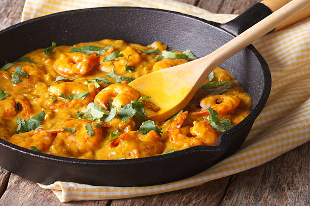 istock Prawns in curry sauce in a frying pan close-up. Horizontal 479606298