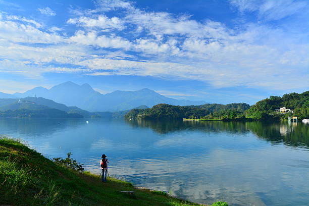 istock Tranquil lakeshore scenery  and female photographer 479607384