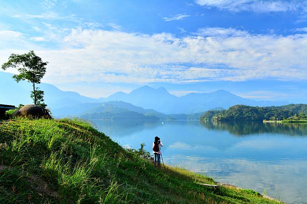 istock Tranquil lake scenery  and female photographer 479607692