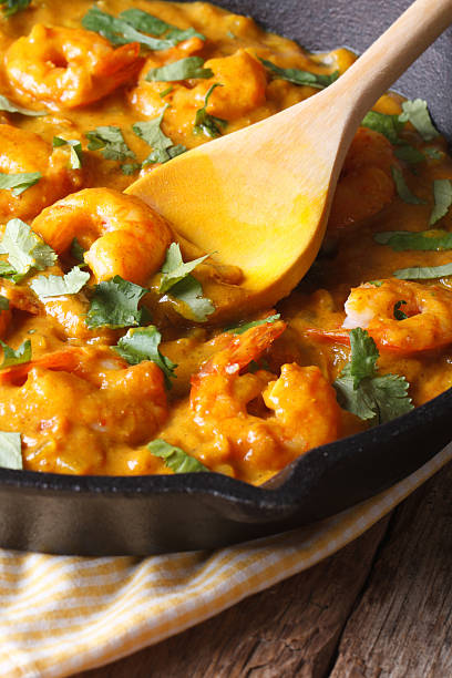 istock Prawns in curry sauce in frying pan macro. vertical, rustic 479608360