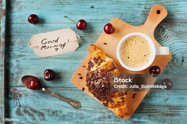 Breakfast With Fresh Croissant Coffee Cherries And Note Stock Photo - Download Image Now