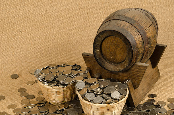 istock Stack of coins with wooden barrel 479610470