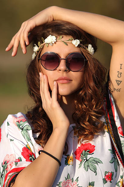 Sexy girl hippie in sunglasses looking at the camera stock photo