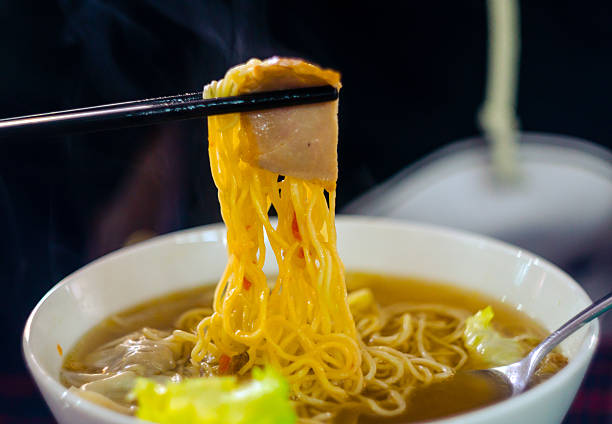 Noodle char siu and wonton A both of noodle, served with char siu and wonton. This dish is represent for Chinese culture. Yellow noodle is submerged under the delicious soup seramic stock pictures, royalty-free photos & images