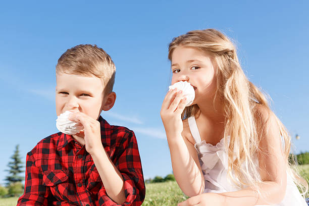 istock Vivacious little boy and girl eating marshmallow 479616428