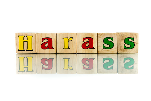 harass colorful wooden word block on the white background