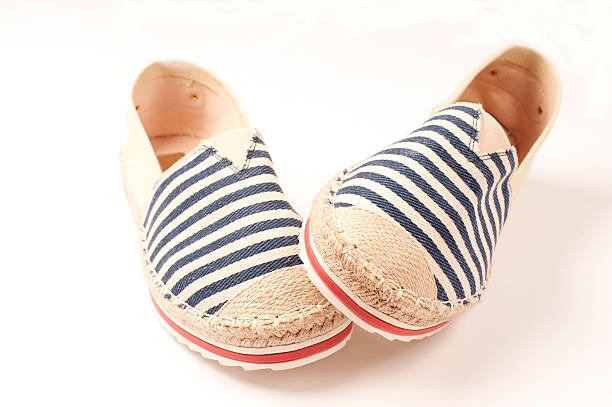 istock Pair of beige espadrilles with blue and red pattern 479628962