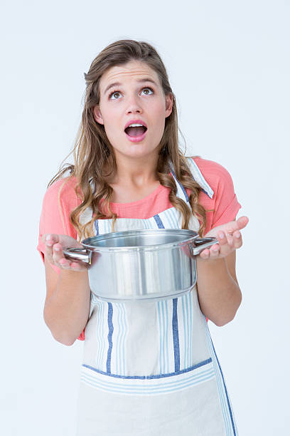 istock Surprised hipster woman holding pressure cooker 479629166