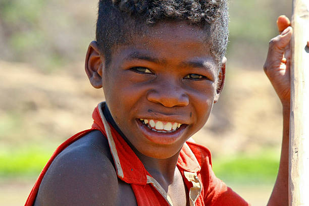 istock Young Malagasy african boy rowing traditional canoe on river 479630458