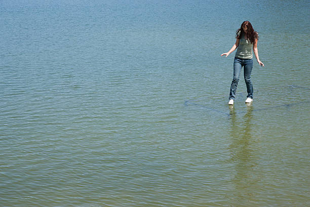 mulher em pé na água - andando em água - fotografias e filmes do acervo