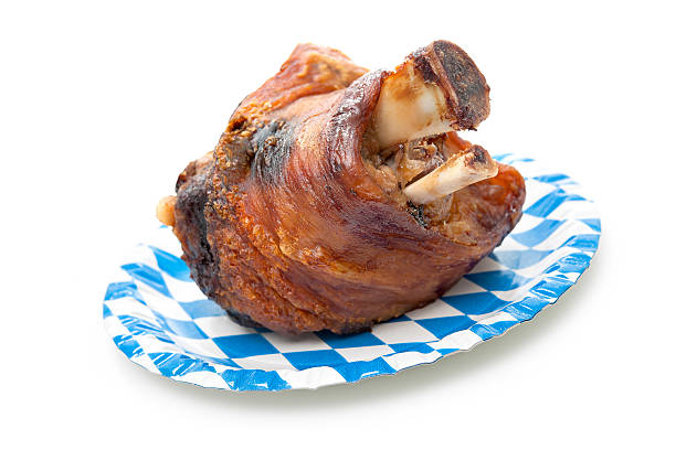 Roasted Schweinshaxe Roasted Schweinshaxe (German pork leg, pork knuckle) isolated on white background pork hock stock pictures, royalty-free photos & images