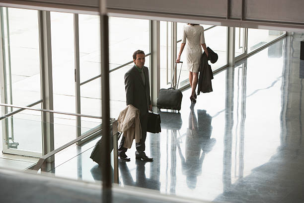 Business people with suitcases in building lobby  Traveled stock pictures, royalty-free photos & images