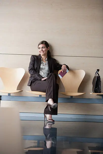 Photo of Businesswoman holding passport and airline ticket