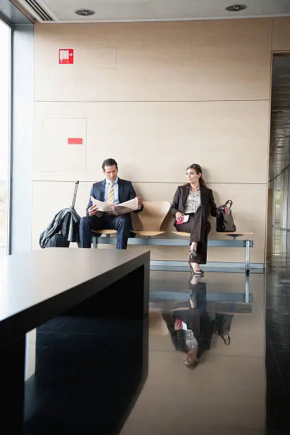 Photo of Business people sitting in waiting area