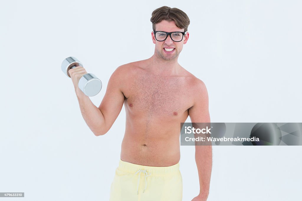 Geeky hipster posing topless with dumbbell Geeky hipster posing topless with dumbbell on white background 20-24 Years Stock Photo