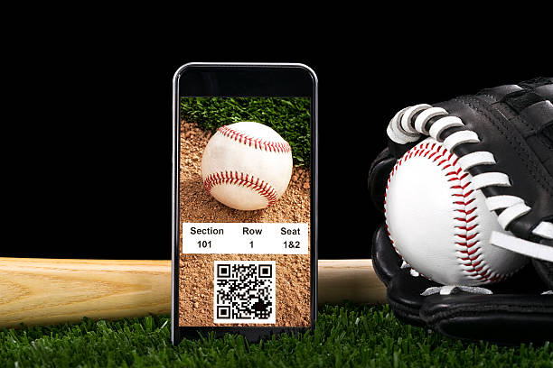 Smart Phone with online baseball tickets A Smart Phone displaying online baseball tickets with QR/Bar code, sitting on the turf with a baseball, glove and bat against a night sky. online baseball betting site stock pictures, royalty-free photos & images