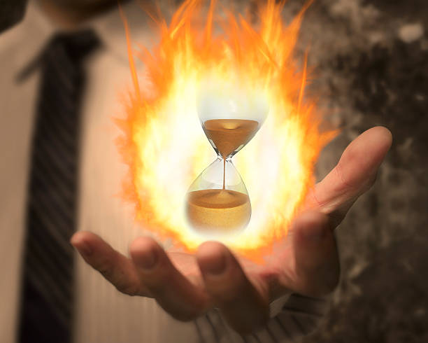 istock Hourglass with fire ball in business man's hand 479641302