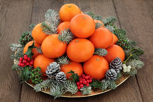 Oranges for decoration for the new year. Decorating oranges with cloves for the holiday.