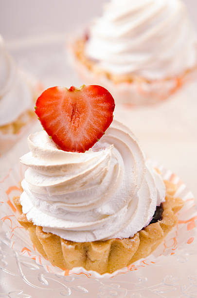 cake with white cream and fresh strawberries on a stand