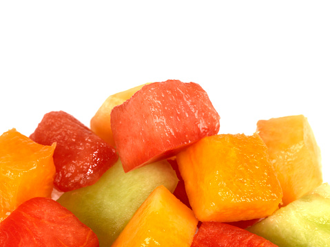 a DSLR royalty free digital image of a pile or stack of fresh ripe juicy melons in a fruit salad, consisting of watermelon, gala melon and cantellope melon, an ideal low fat low calorie snack or dessert or lunchtime snack, healthy food option for dieters or vegetarians, isolated against a plain white background