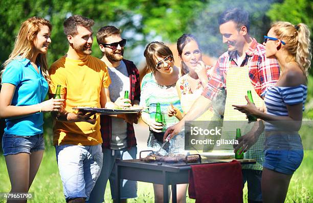Friends Having Barbecue Party Stock Photo - Download Image Now - 20-29 Years, 2015, 30-39 Years