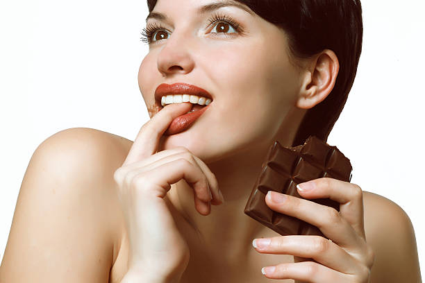 istock young woman eating a delicious chocolate 479652916