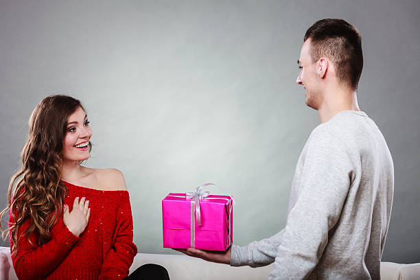 istock happy romantic couple with gift 479653030