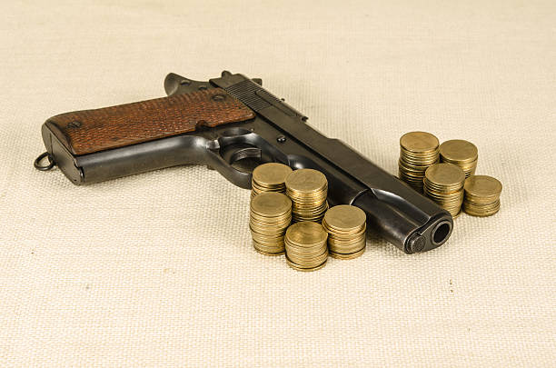 istock Gun and money 479653360