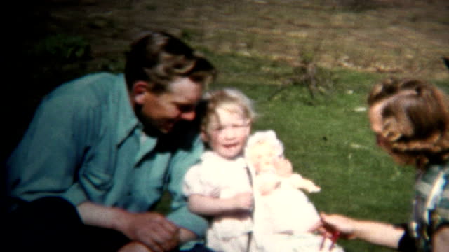 (8mm Vintage) 1952 Dad Mom & Baby Farm Picnic, Chickens In Background. Iowa, USA.