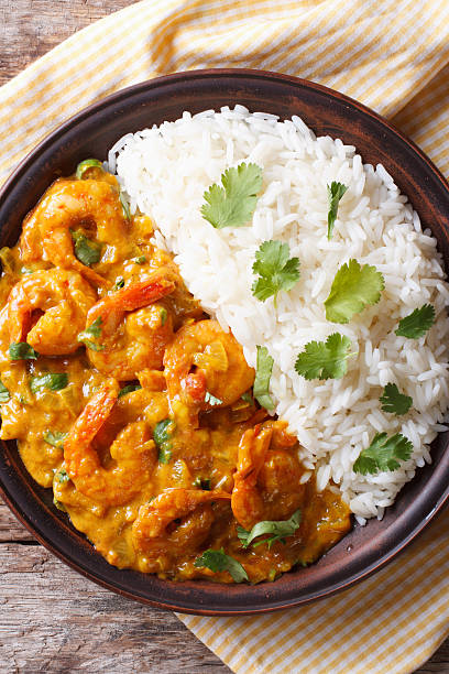 istock Shrimps curry with rice on plate close-up. vertical top view 479660118